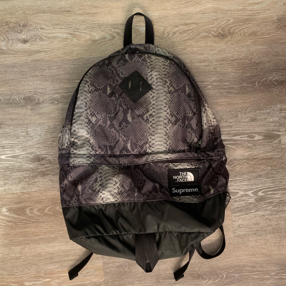 SUPREME X NORTH FACE snake print backpack